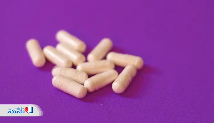 Iron supplement capsules on a purple background, often recommended for patients with low hemoglobin levels identified through the MCH test